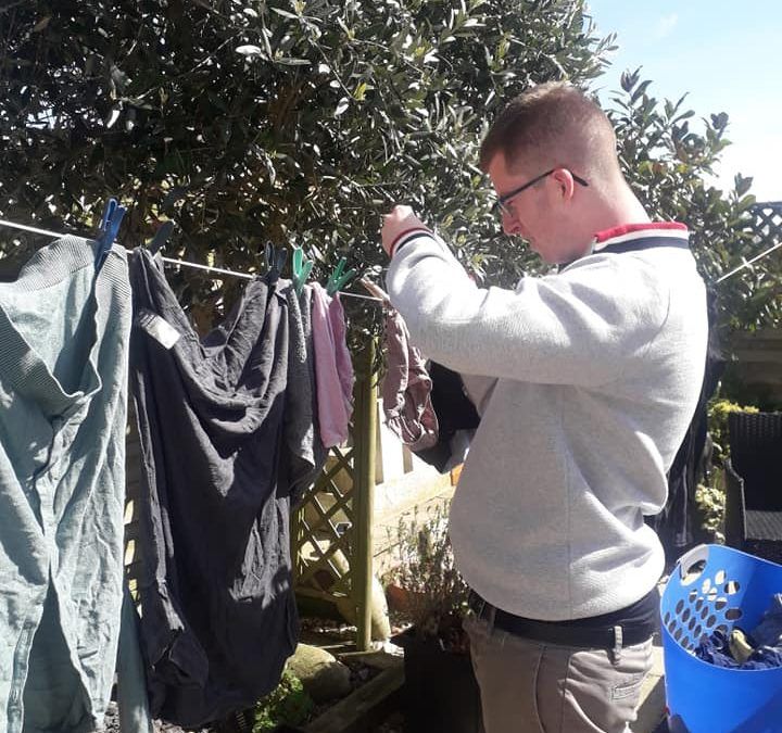 Jacob pegging out washing